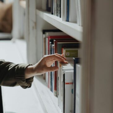 Person in Black Long Sleeve Shirt Holding Book - cottonbro studio