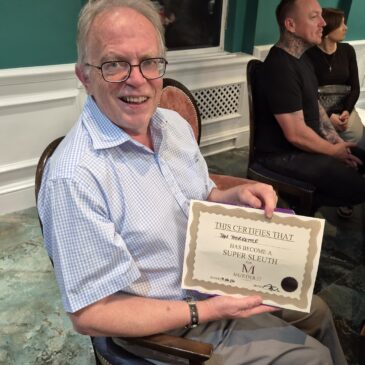 man holding winners certificate